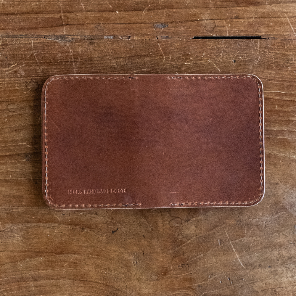 Brown calf leather wallet with rounded corners and perimeter stitching stamped with Nicks Handmade Boots