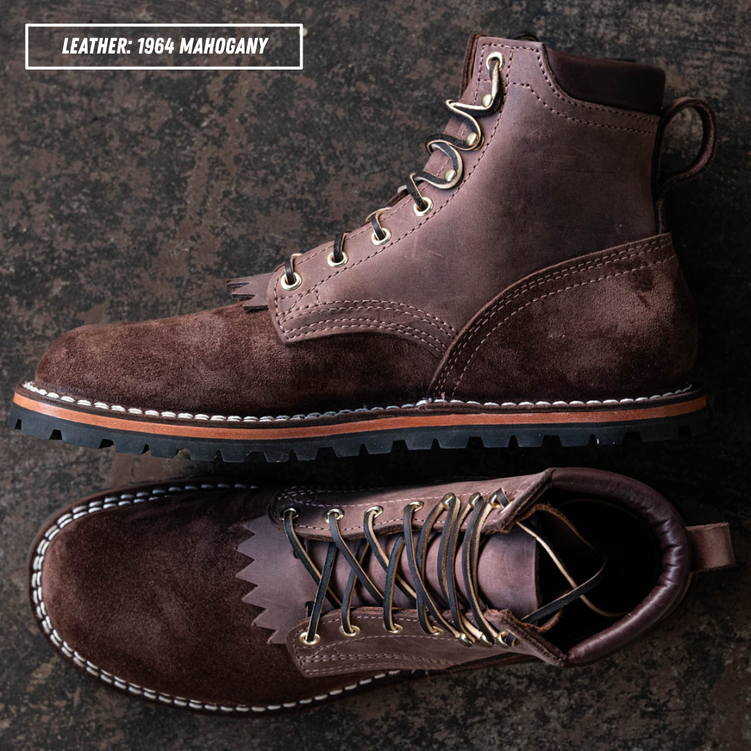 A pair of dark brown leather lace-up boots shown from top and side views on a dark textured background, with text in the upper left reading 'LEATHER: 1964 MAHOGANY'.