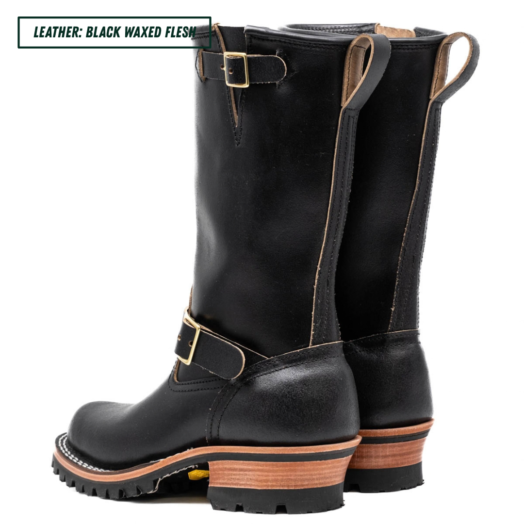 A pair of tall black leather boots with gold-tone buckle straps and stacked wood-look heels, shown on a white background with a text label in the top left corner.