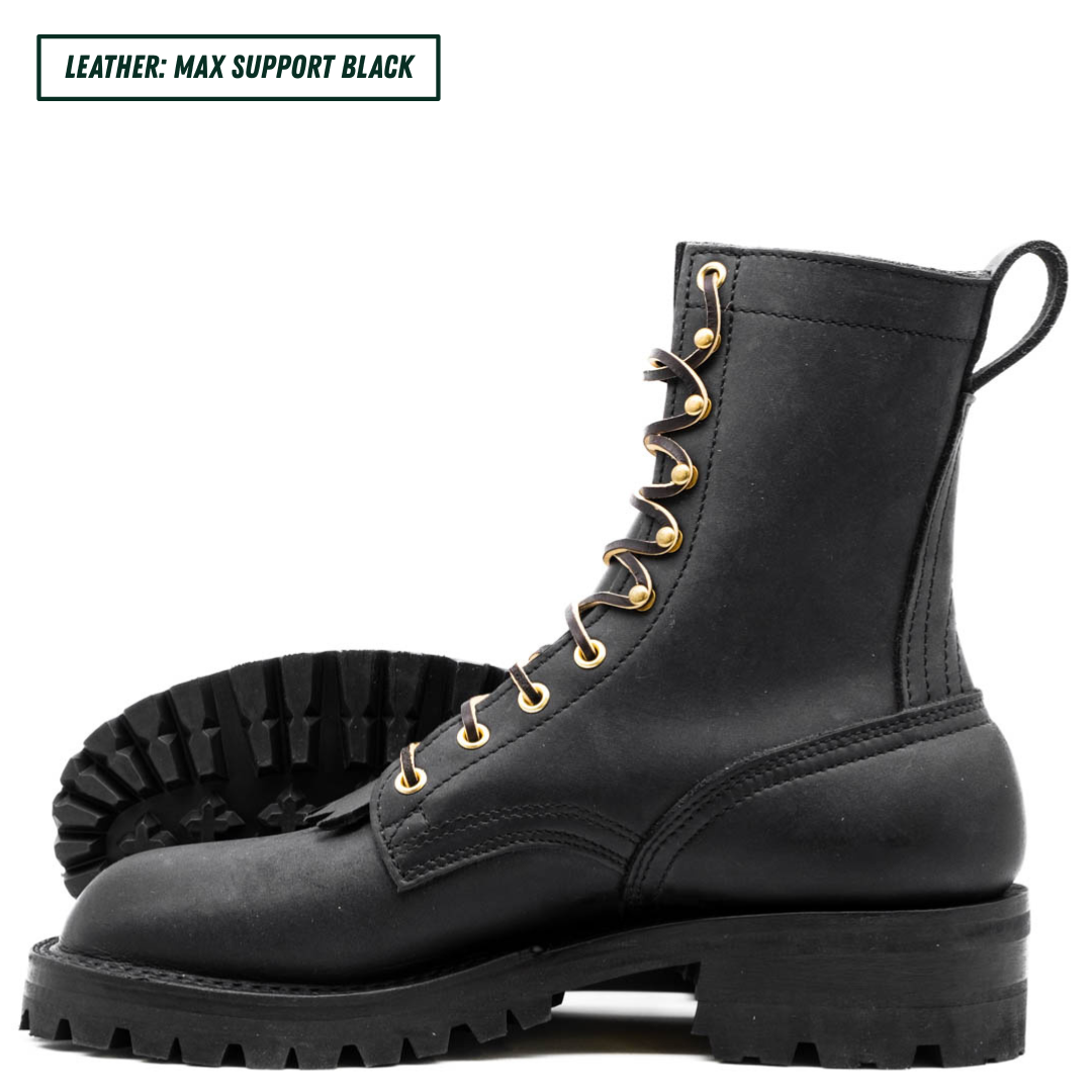 All black leather boots with lug soles. One sitting up side profile while the other is laying down showing the outsole. Top left reads "LEATHER: MAX SUPPORT BLACK."