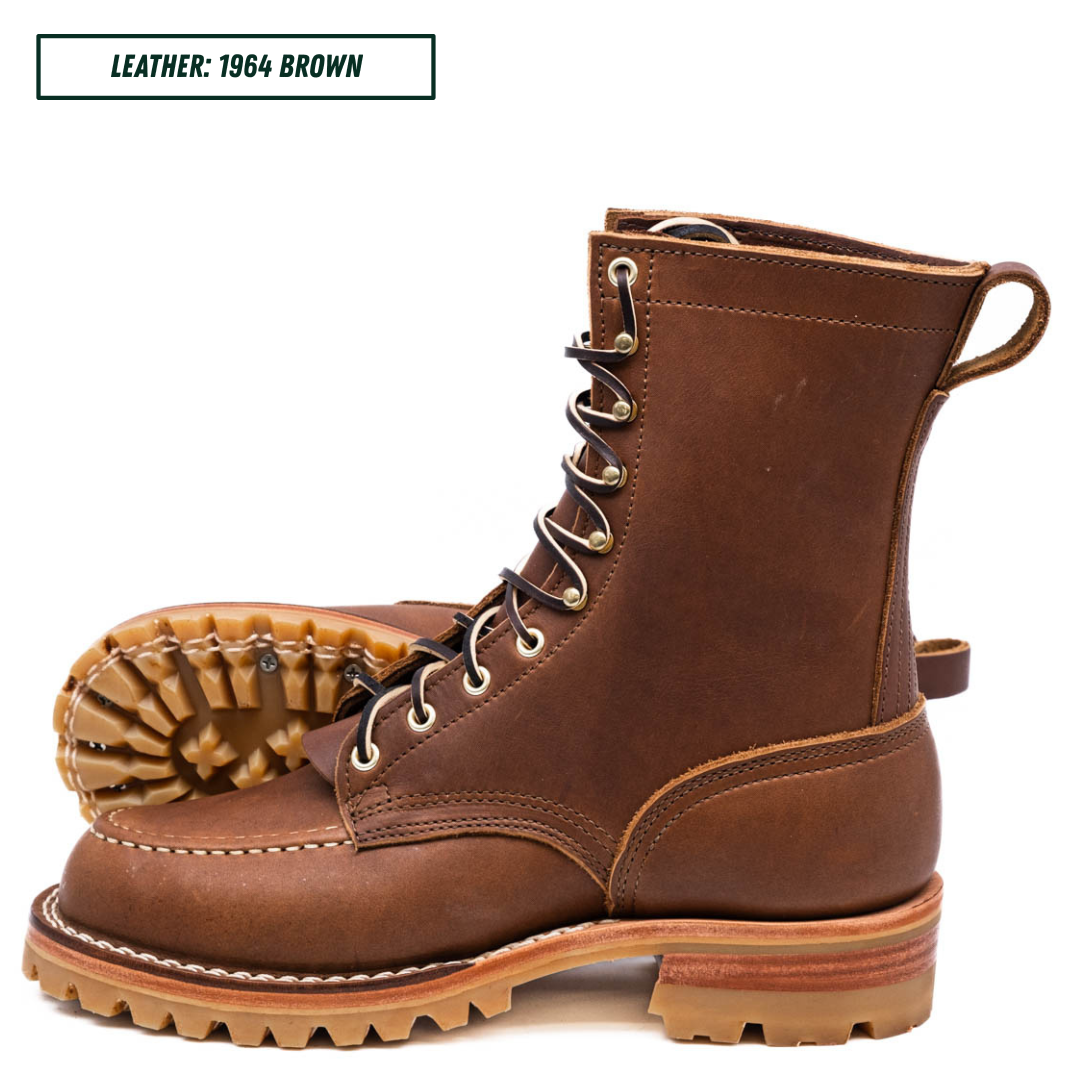 A pair of brown leather lace-up work boots shown on a white background, with one boot standing upright and the other lying on its side to display the sole. A text label in the top left reads 'LEATHER: 1964 BROWN'.