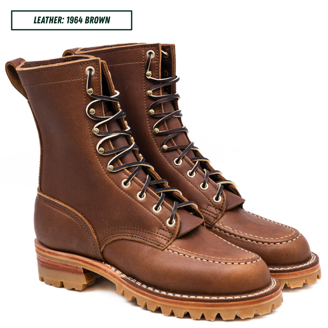 A pair of brown leather lace-up work boots shown on a white background with a text label in the top left corner that reads 'LEATHER: 1964 BROWN'.