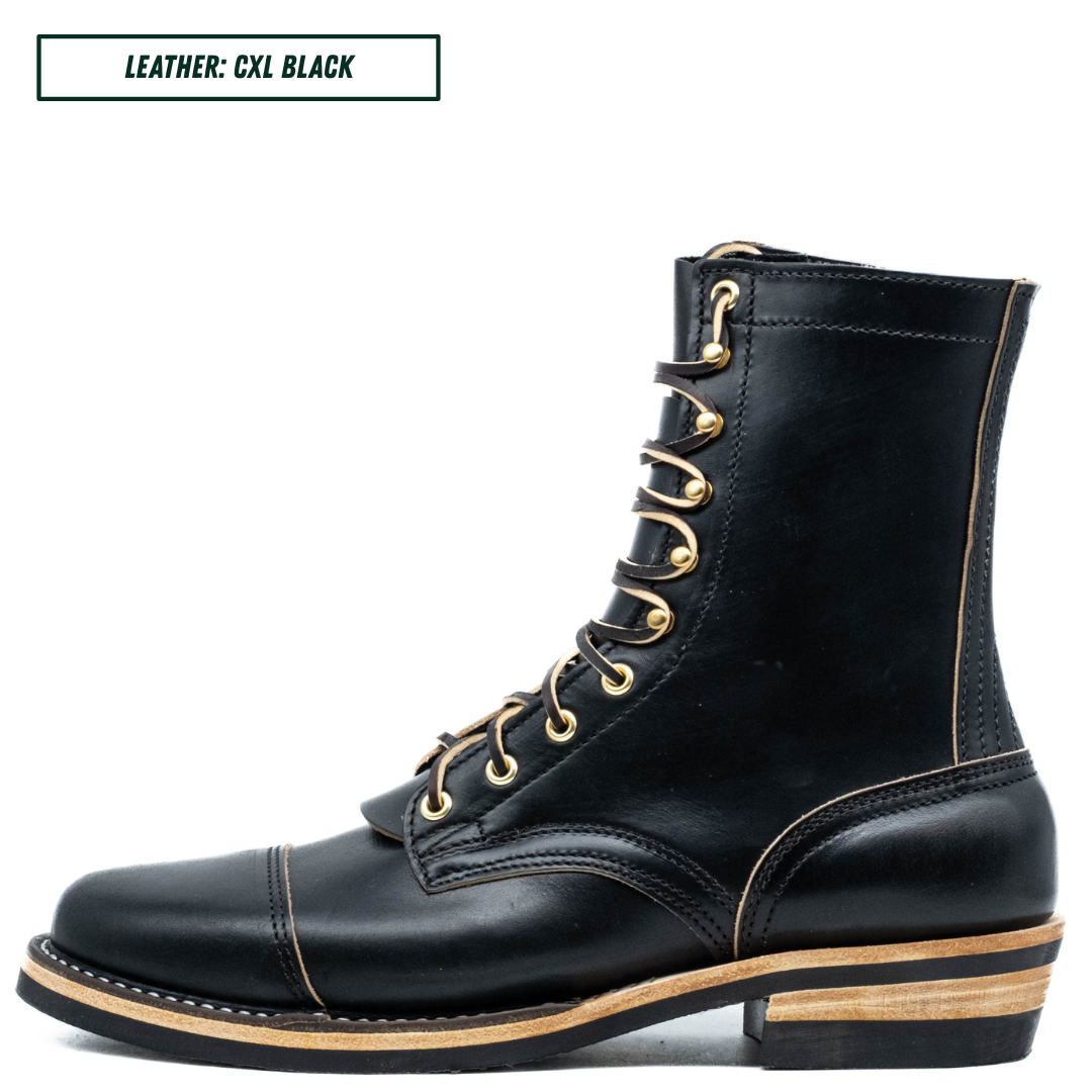 A black leather lace-up ankle boot with gold-tone eyelets and laces, featuring a stacked wood-look heel and light tan contrast stitching, shown on a white background with a text label in the top-left corner.