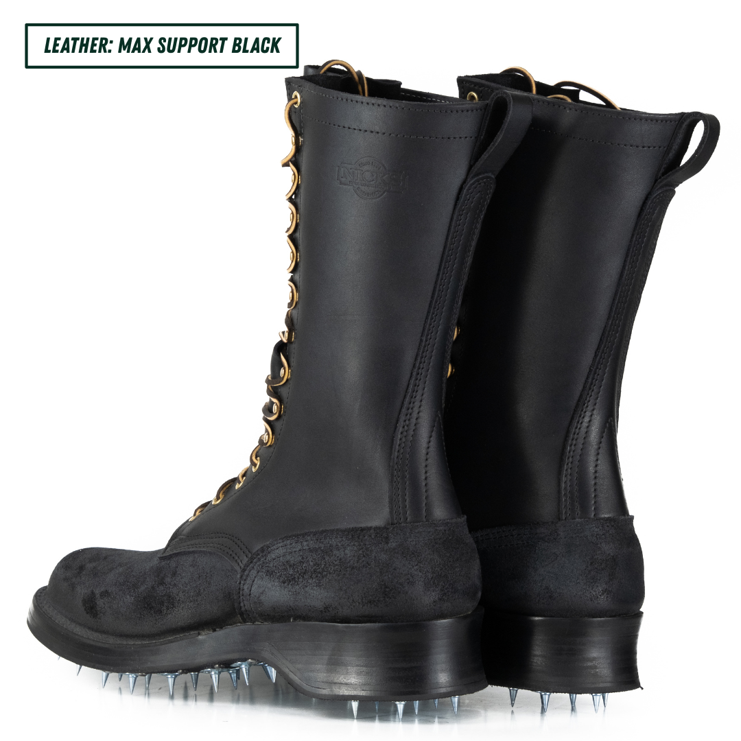 A pair of black leather knee-high boots with metal spikes on the soles, shown from a three-quarters angle on a white background. A text overlay in the top-left corner reads 'LEATHER: MAX SUPPORT BLACK'.