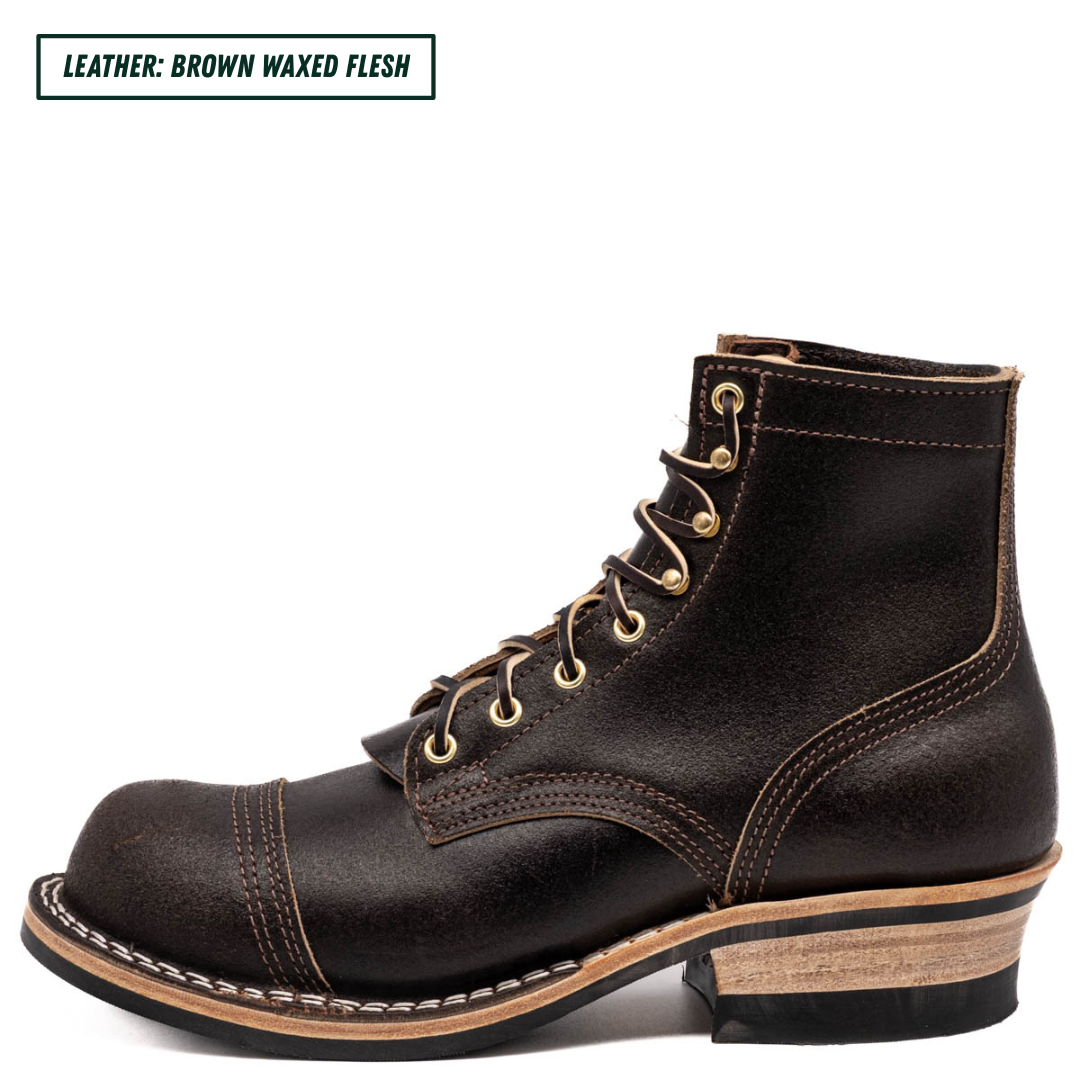 A dark brown leather lace-up boot with gold-toned metal eyelets and a stacked wood-look heel, shown on a white background with a text label in the top-left corner reading 'LEATHER: BROWN WAXED FLESH'.