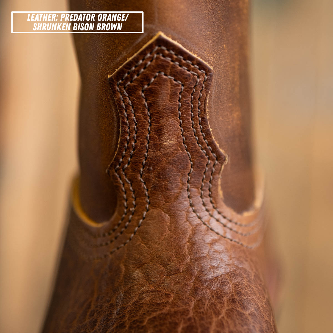 Detail shot of instep on Palouse western boot. Top left reads 'LEATHER: PREDATOR ORANGE/ SHRUNKEN BISON BROWN'.