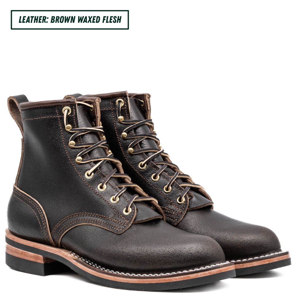 A pair of dark brown leather lace-up boots with gold-toned metal eyelets and laces, shown on a white background with a text label in the top-left corner that reads 'LEATHER: BROWN WAXED FLESH'.