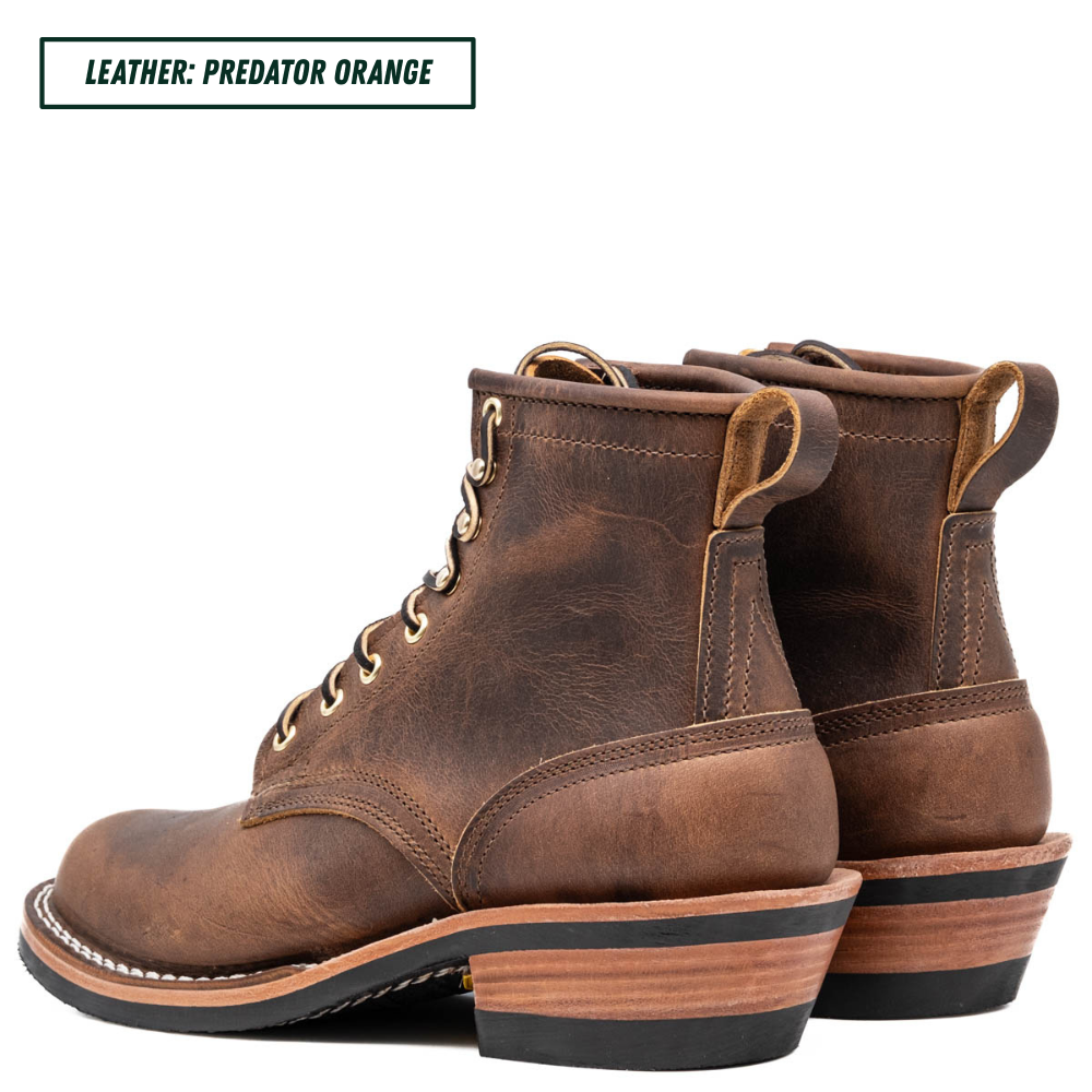 A pair of rugged lace-up ankle boots in distressed brown leather, shown from a side-rear angle on a white background. A text label in the top-left corner reads 'LEATHER: PREDATOR ORANGE'.
