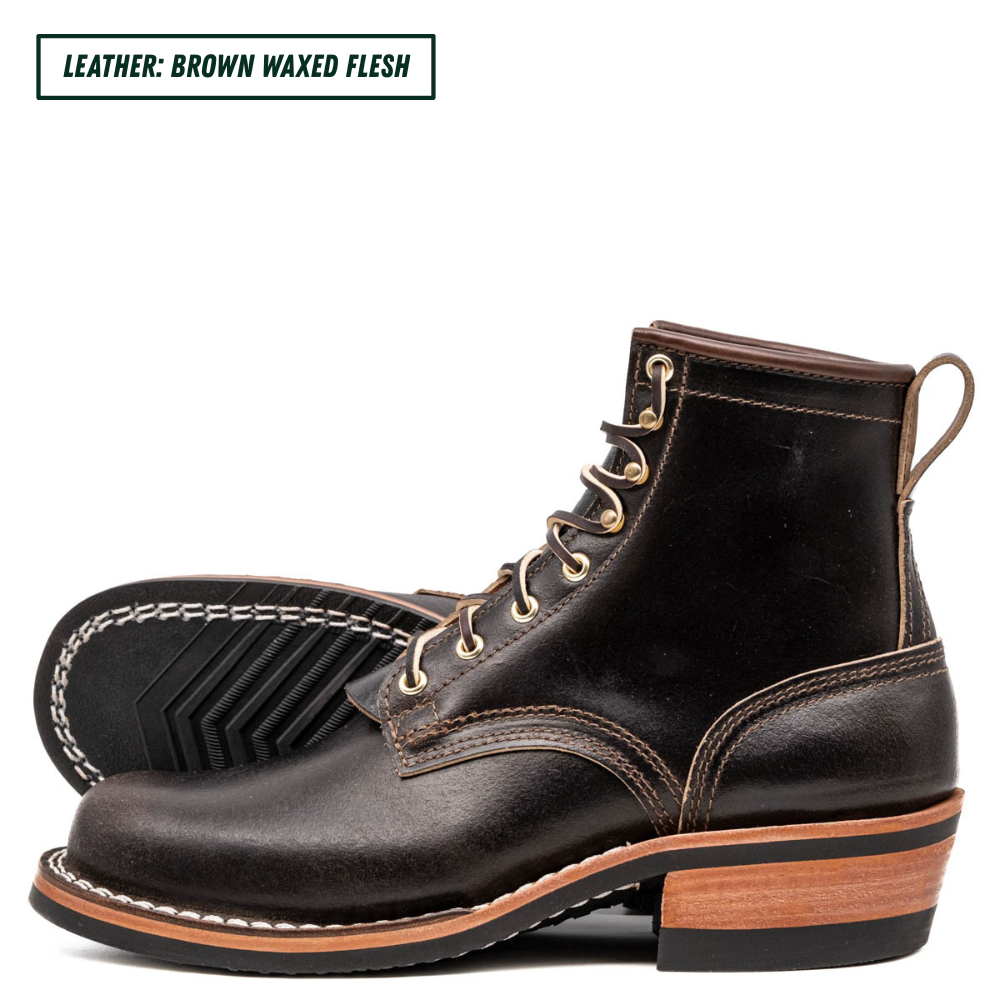 A pair of men's brown waxed leather lace-up boots shown on a white background, with one boot standing upright and the other lying on its side to display the sole. A text label in the top-left corner reads 'LEATHER: BROWN WAXED FLESH'.