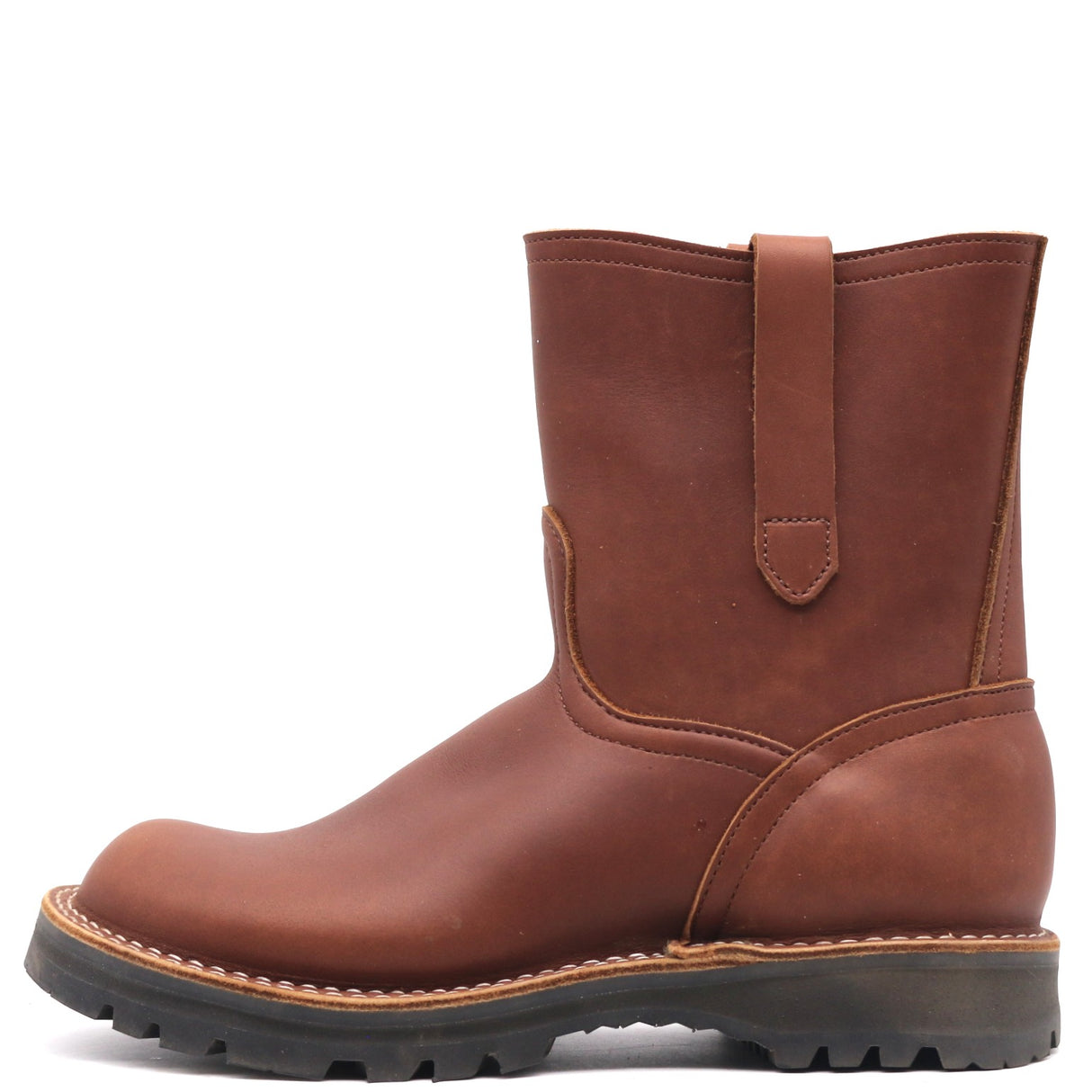 A brown leather mid-calf work boot with a rugged black sole and a pull strap on the back collar, shown from a side profile view against a white background.