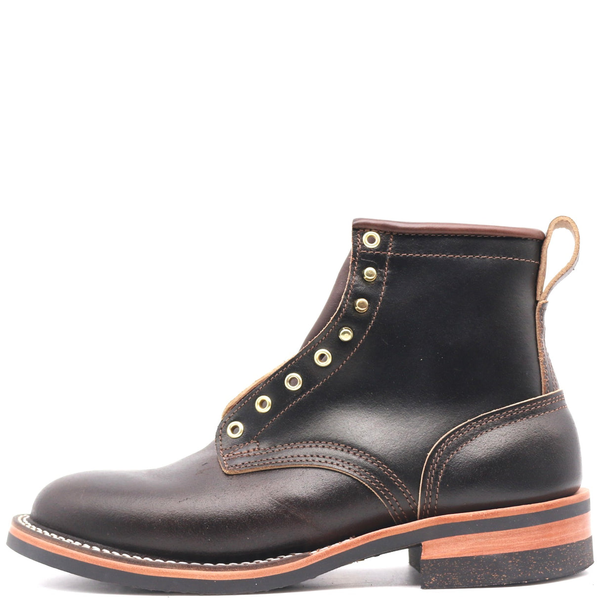 A dark brown leather ankle boot with gold-tone metal eyelets, contrast stitching, and a tan pull loop, shown from a side profile on a white background.