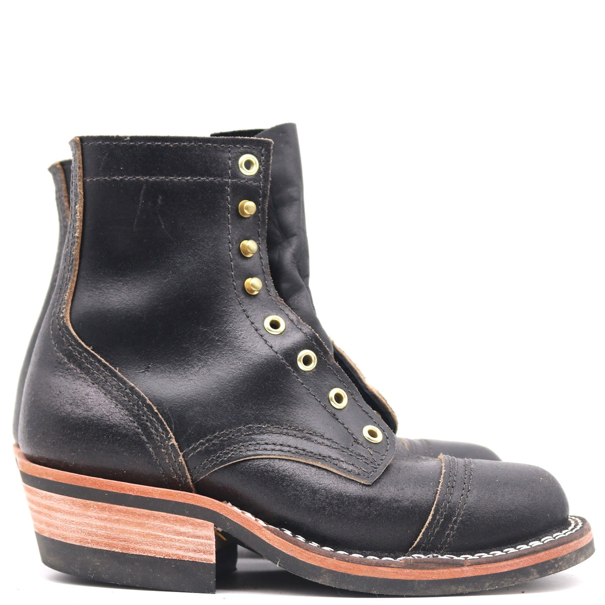 A single black leather lace-up ankle boot with gold-tone metal eyelets, a stacked wood-look heel, and contrast stitching, shown against a plain white background.