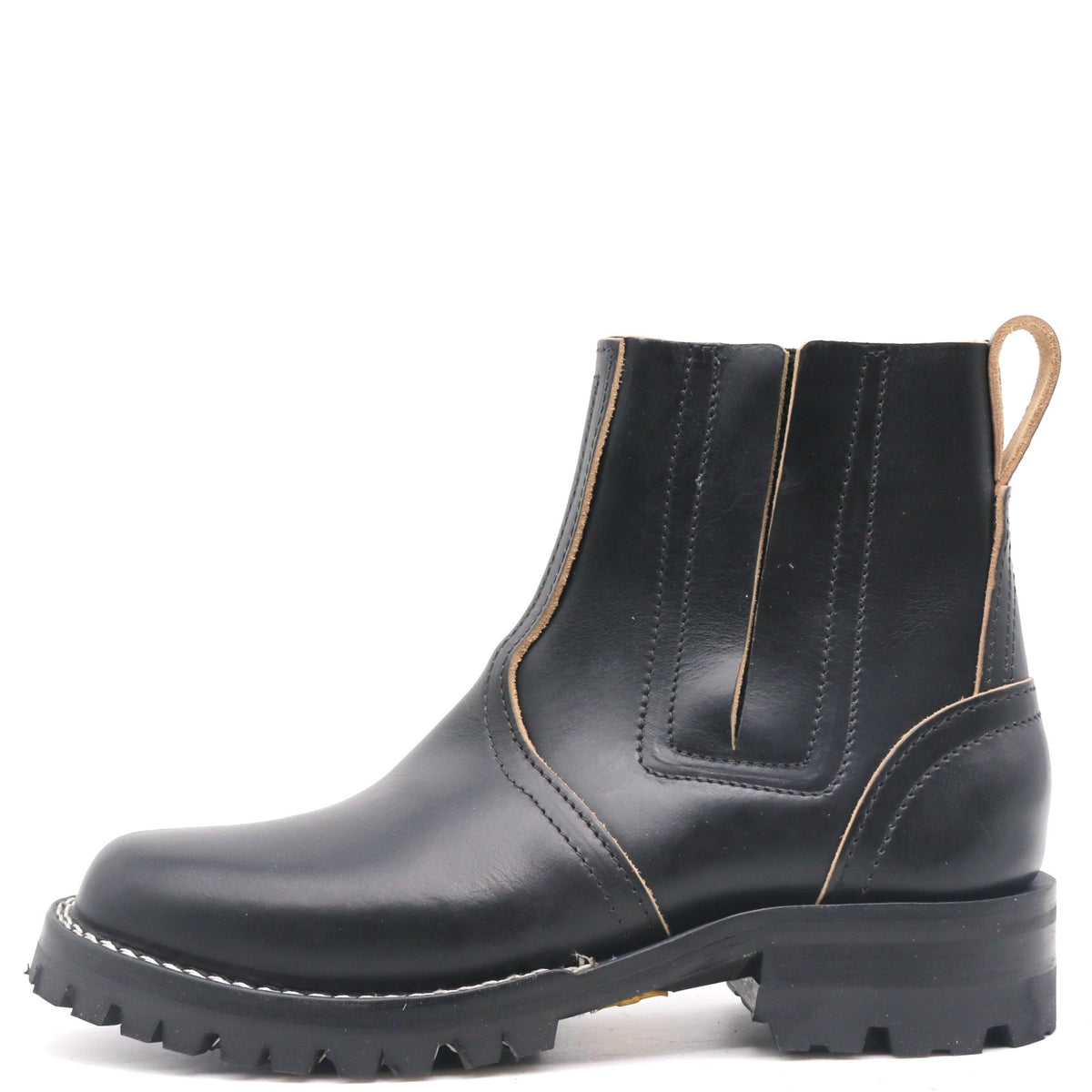 A black leather Chelsea boot with tan contrast stitching, a black rubber sole, and a pull tab on the heel, shown from a side profile on a white background.