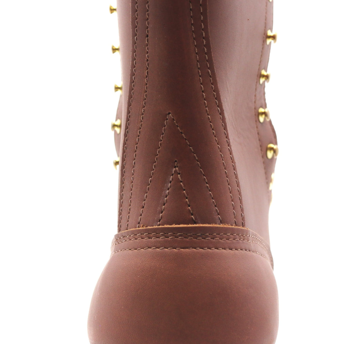 Close-up of a brown leather boot featuring decorative gold-tone studs and stitching on a white background.