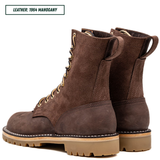 A pair of dark brown suede lace-up boots with tan soles and gold-tone laces, shown from the side and back on a white background. A text label in the top left reads 'LEATHER: 1964 MAHOGANY'.