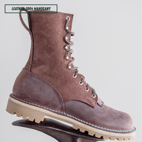 A single lace-up ankle boot in dark brown leather with a chunky beige lug sole, shown on a stand against a light gray background. A text label in the top left reads 'LEATHER - 1964 MAHOGANY'.