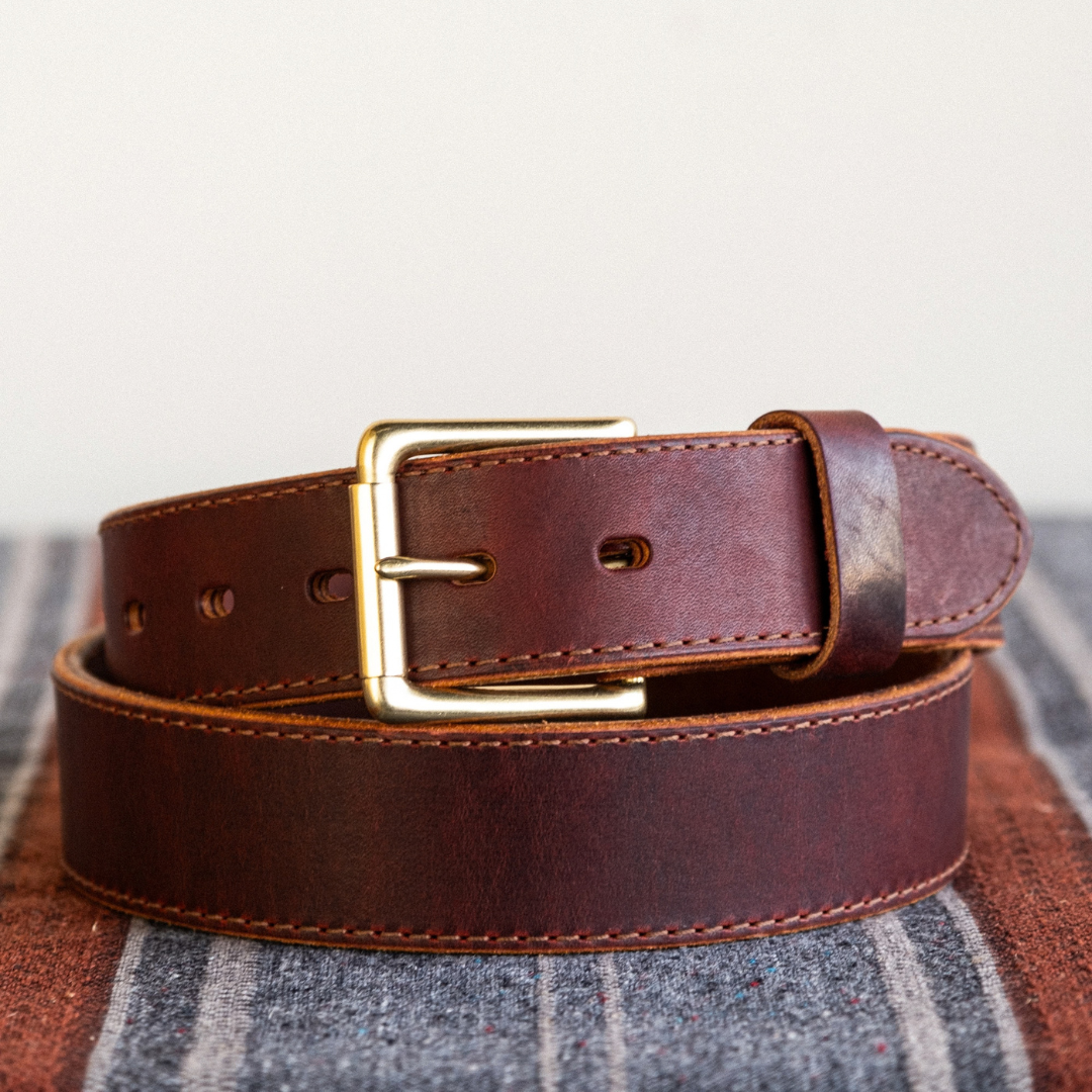 Cypress Raisin Cherry Heritage belt sitting on blanket in front of white background