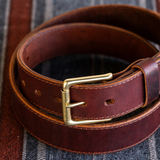 Cypress Raisin Cherry Heritage belt sitting on blanket