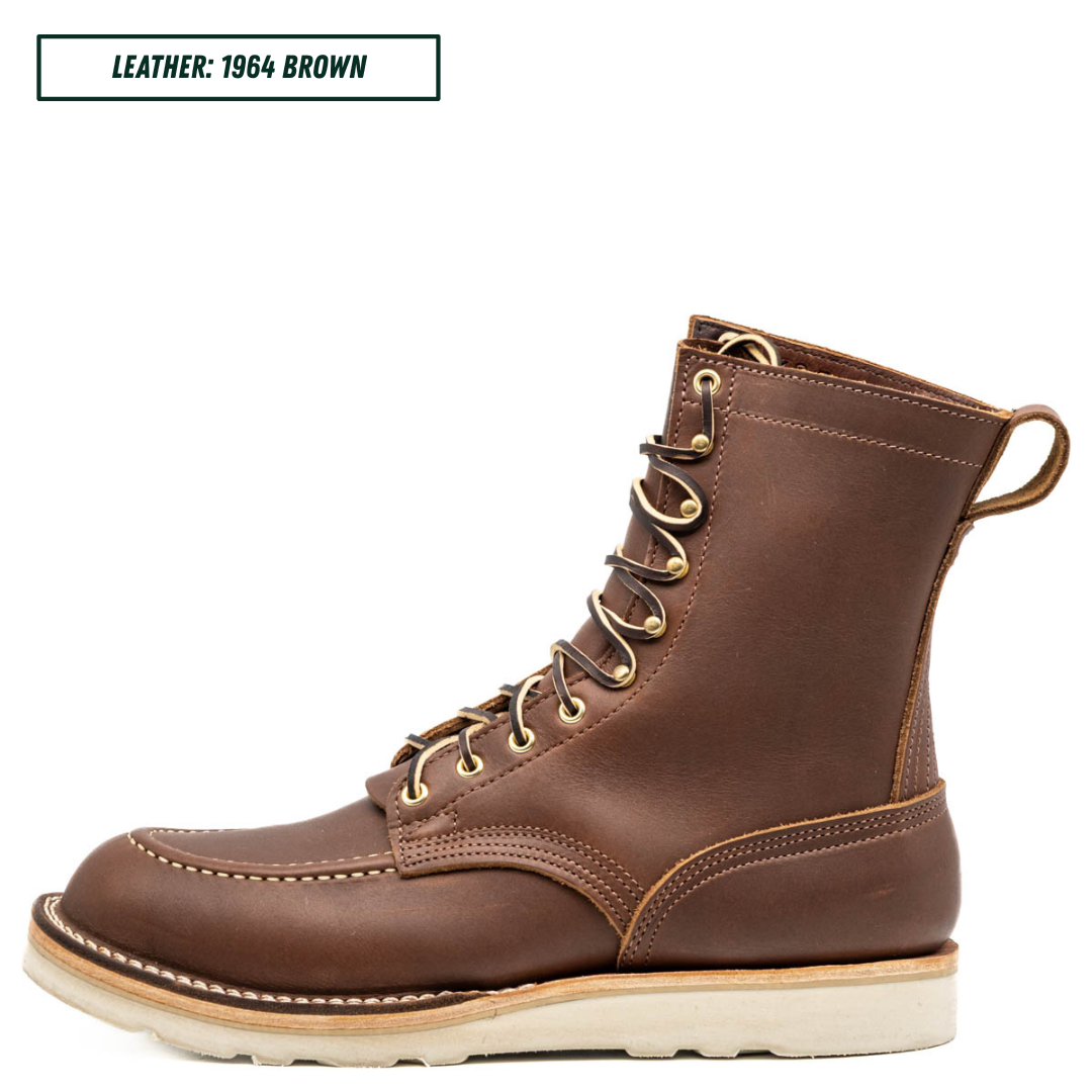 A single brown leather lace-up boot shown in side profile on a white background, with a small text label in the top-left corner reading 'LEATHER: 1964 BROWN'. The boot has tan contrast stitching, brass eyelets, and a light-colored sole.