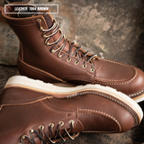 Two brown leather lace-up boots shown on a textured stone surface, with one boot standing upright and the other lying on its side to show the sole. A text label in the top left reads 'LEATHER: 1964 BROWN'.