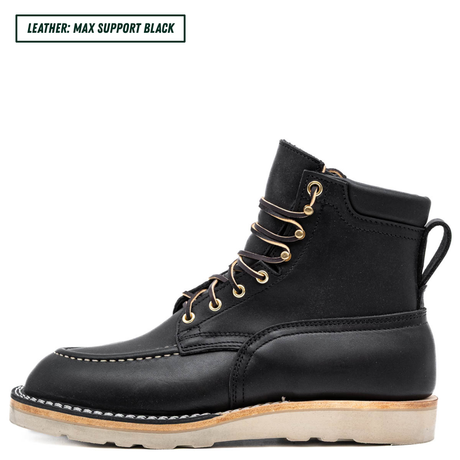 A black leather lace-up ankle boot with gold metal eyelets and a light tan sole, shown in a side profile on a white background. A text label in the top-left corner reads 'LEATHER: MAX SUPPORT BLACK'.
