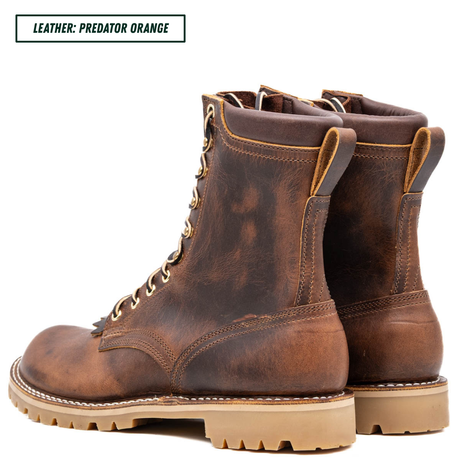 A pair of distressed brown leather lace-up boots with tan soles, shown from a three-quarter angle on a white background. A text label in the top-left corner reads 'LEATHER: PREDATOR ORANGE'.