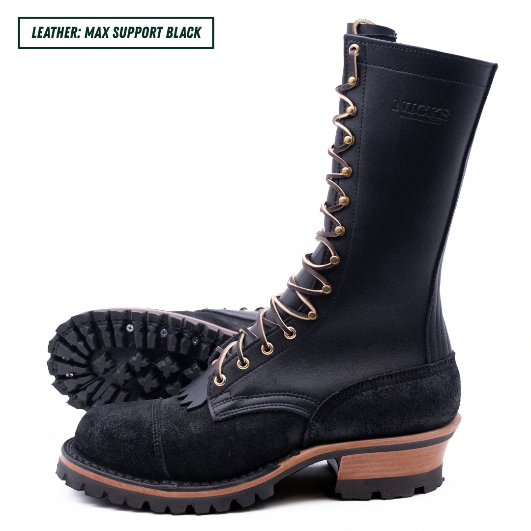 A tall black leather lace-up boot with a rugged sole, shown from the side with another boot placed behind it to display the tread. The text 'LEATHER: MAX SUPPORT BLACK' appears in the top-left corner.
