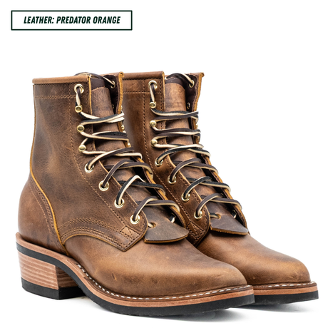 A pair of distressed leather lace-up ankle boots in a brown shade labeled 'LEATHER: PREDATOR ORANGE' in the top-left corner, shown on a clean white background.
