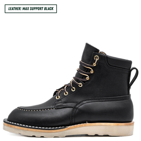 A black leather lace-up ankle boot with gold metal eyelets and a light tan sole, shown in a side profile on a white background. A text label in the top-left corner reads 'LEATHER: MAX SUPPORT BLACK'.