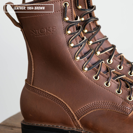 A close-up of a brown leather lace-up boot with gold-tone eyelets and black laces. The embossed brand name 'NICKS' is visible on the side, and a text label reads 'LEATHER: 1964 BROWN'.