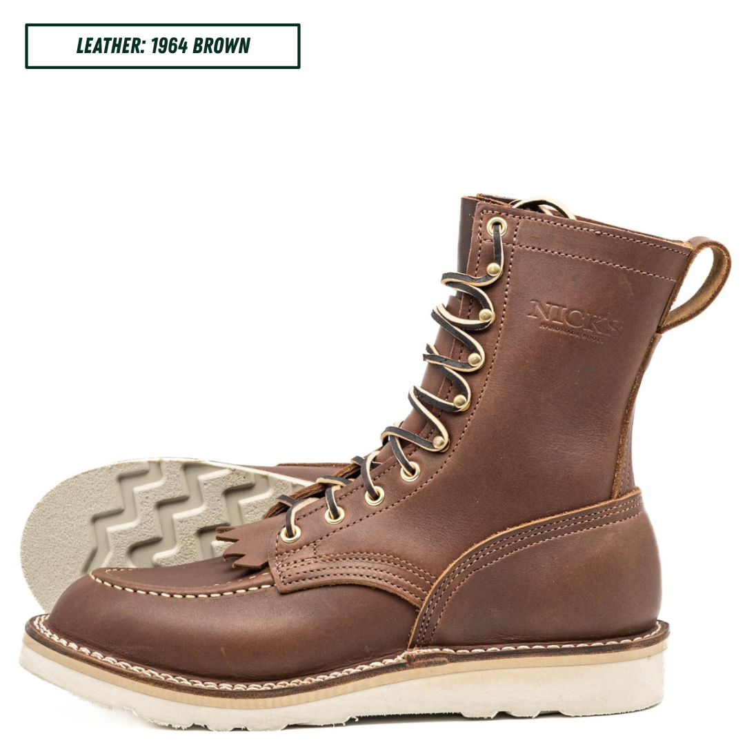 A brown leather lace-up work boot shown in profile with the sole turned up to reveal the tread pattern. The brand name 'Nicks' is embossed on the side, and a text label at the top reads 'LEATHER: 1964 BROWN'.