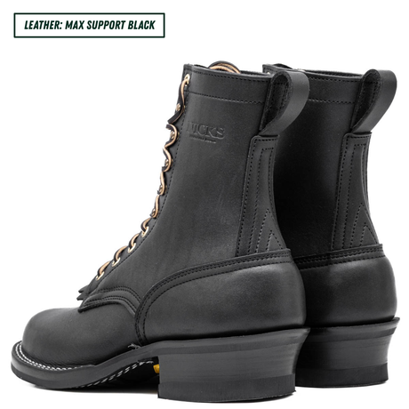 A pair of black leather lace-up boots shown from the side and back on a white background, with a text label in the top-left corner reading 'LEATHER: MAX SUPPORT BLACK'. The brand name 'DICKS' is embossed on the side of the boot.