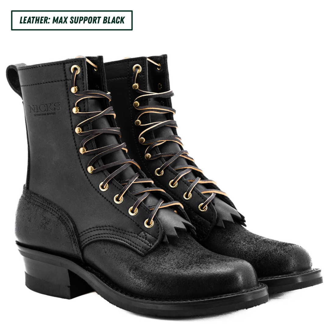 A pair of black leather lace-up boots with gold-tone eyelets and fringe detailing, shown on a white background with a text label in the top left corner.