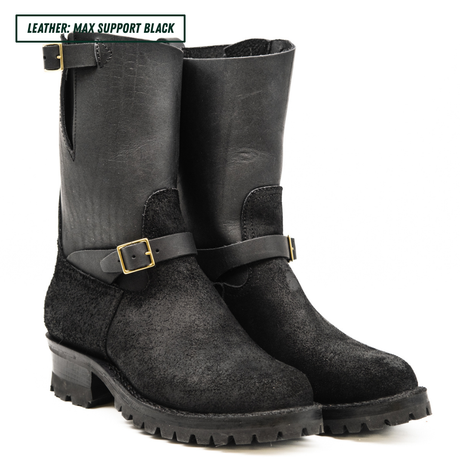 A pair of black leather and suede mid-calf boots with buckle straps, shown on a white background with a text label in the top left corner.