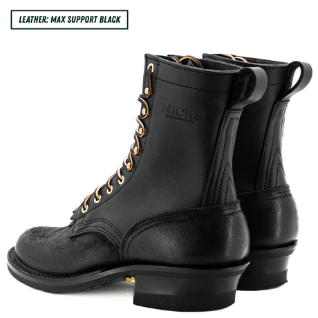 A pair of black leather lace-up boots shown from the side and back on a white background, with a text label in the top-left corner reading 'LEATHER: MAX SUPPORT BLACK'. The brand name 'NICKS' is embossed on the side of the boot.