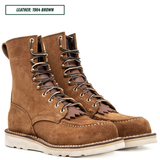 A pair of brown leather lace-up work boots with metal eyelets, white stitching, and thick off-white soles, shown on a white background with a text label reading 'LEATHER: 1964 BROWN'.