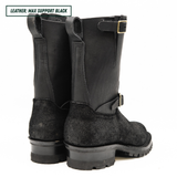Pair of black riding boots with a buckle on a white background