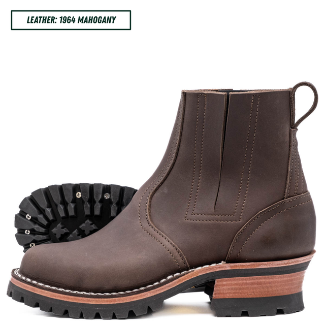 A dark brown leather Chelsea-style ankle boot with a chunky stacked heel, black lug sole, and a light tan midsole section. A black outsole is shown behind the main boot.
