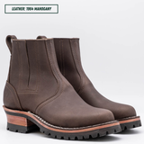 A dark brown leather Chelsea-style ankle boot with a chunky stacked heel, black lug sole, and a light tan midsole section. Boots sitting together facing forward right. Top left reads "LEATHER: 1964 MAHOGANY."