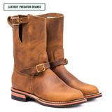 A pair of distressed brown leather boots with buckle straps, shown on a white background with a text label at the top reading 'LEATHER: PREDATOR ORANGE'.