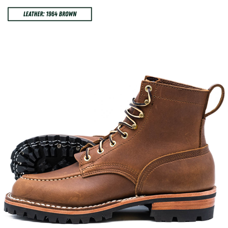 A pair of brown leather lace-up moc toe work boots shown on a white background, with one boot standing upright and the other lying on its side to display the sole. A text label in the top left reads 'LEATHER: 1964 BROWN'.
