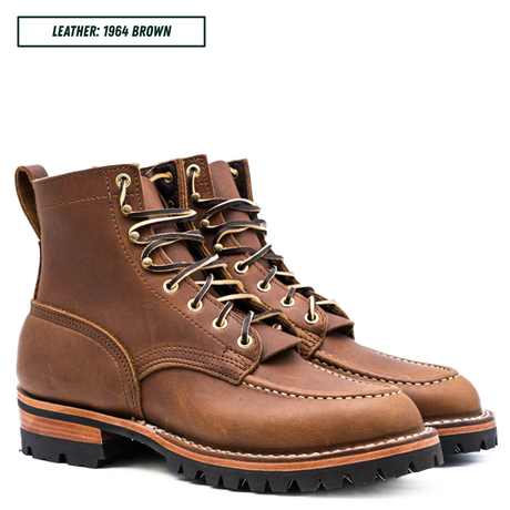 A pair of brown leather lace-up boots shown on a white background, with a text label in the top-left corner reading 'LEATHER: 1964 BROWN'. The boots feature tan stitching, brass eyelets, and a rugged black lug sole.