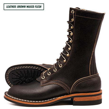 A pair of dark brown waxed leather lace-up boots with gold-tone eyelets and white contrast stitching, shown on a white background with a text label in the top-left corner.