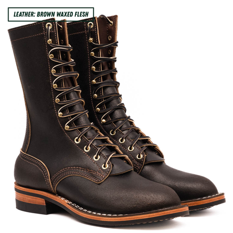A pair of dark brown waxed leather lace-up boots with brass eyelets and white contrast stitching, shown on a white background with a text label in the top left corner.
