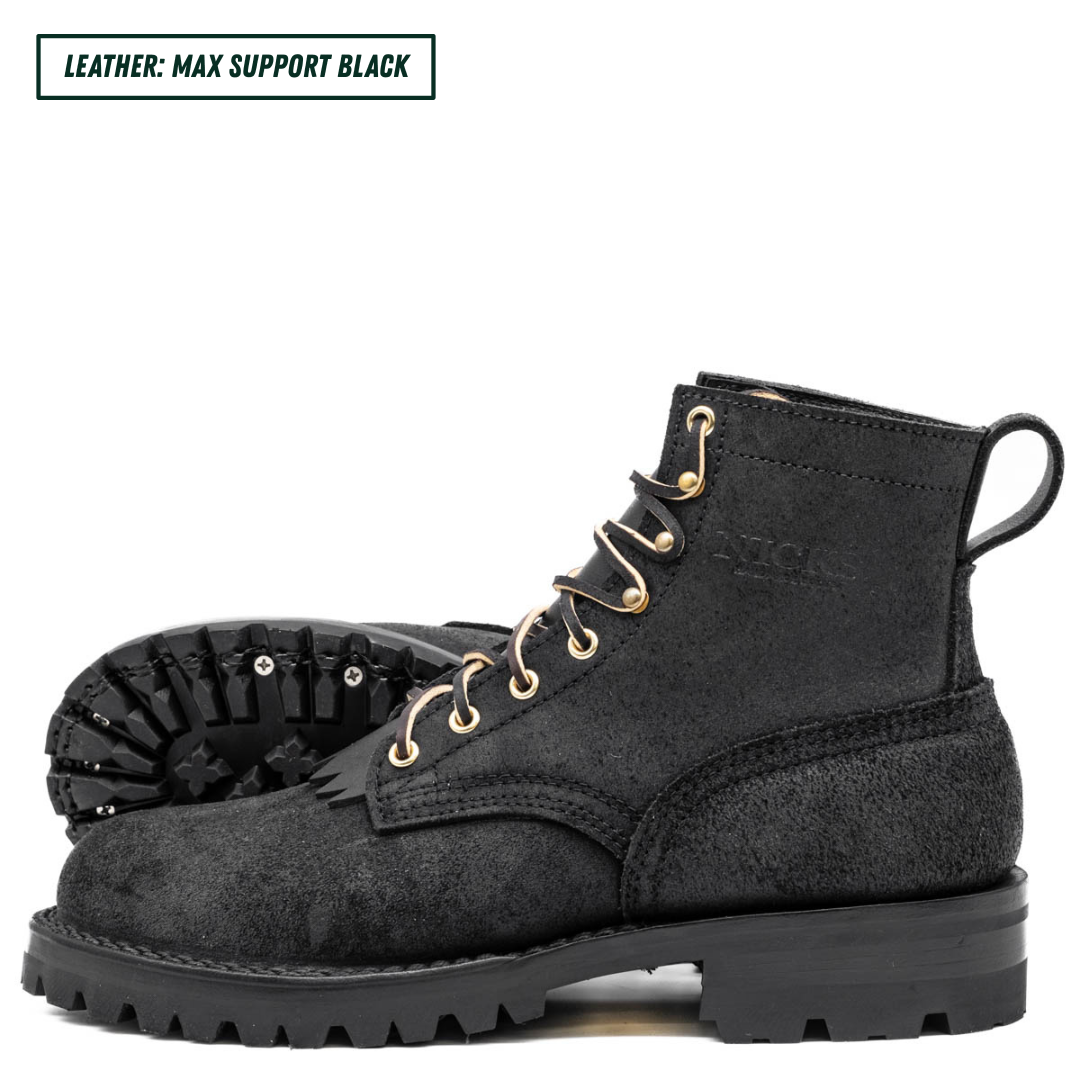 A pair of black leather lace-up boots with gold-toned metal eyelets and a rugged black sole, shown on a white background with a text label in the top-left corner reading 'LEATHER: MAX SUPPORT BLACK'.