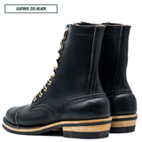 A pair of black leather lace-up ankle boots with gold-tone eyelets and a stacked wood-and-leather heel, shown on a white background with a text label in the top left corner.