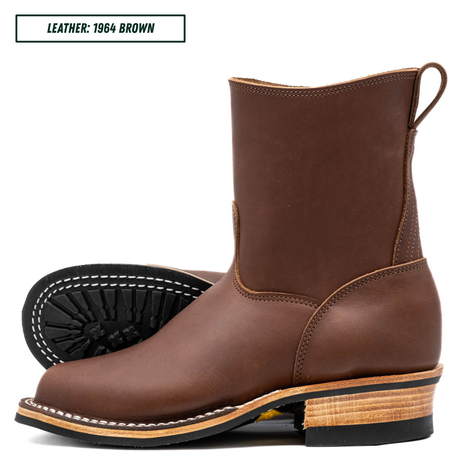A brown leather mid-calf boot shown in side profile with a second boot turned to show the black treaded sole. A text label in the top left reads 'LEATHER: 1964 BROWN'.