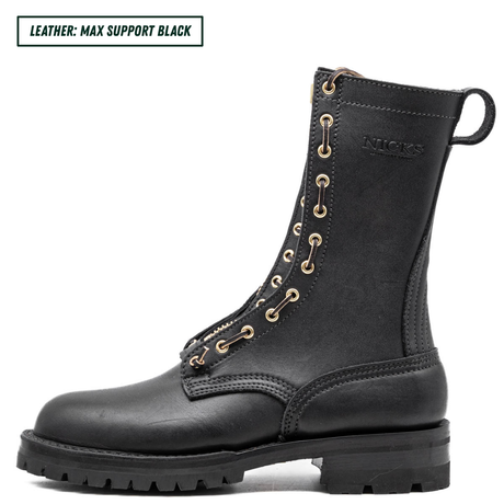 A black leather lace-up ankle boot shown in profile on a white background, with a small text label in the top-left corner reading 'LEATHER: MAX SUPPORT BLACK'. The boot has gold-tone eyelets, a pull tab, and the brand name 'NICKS' embossed on the side.