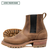 A pair of rugged brown leather ankle boots with black elastic side panels and a chunky lug sole, shown on a white background with a text label reading 'LEATHER: PREDATOR ORANGE'.