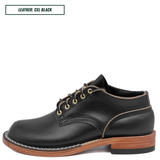 A black leather lace-up dress shoe with gold-toned laces and contrast stitching, shown from a side profile on a white background. A text box in the top-left corner reads 'LEATHER: CXL BLACK'.